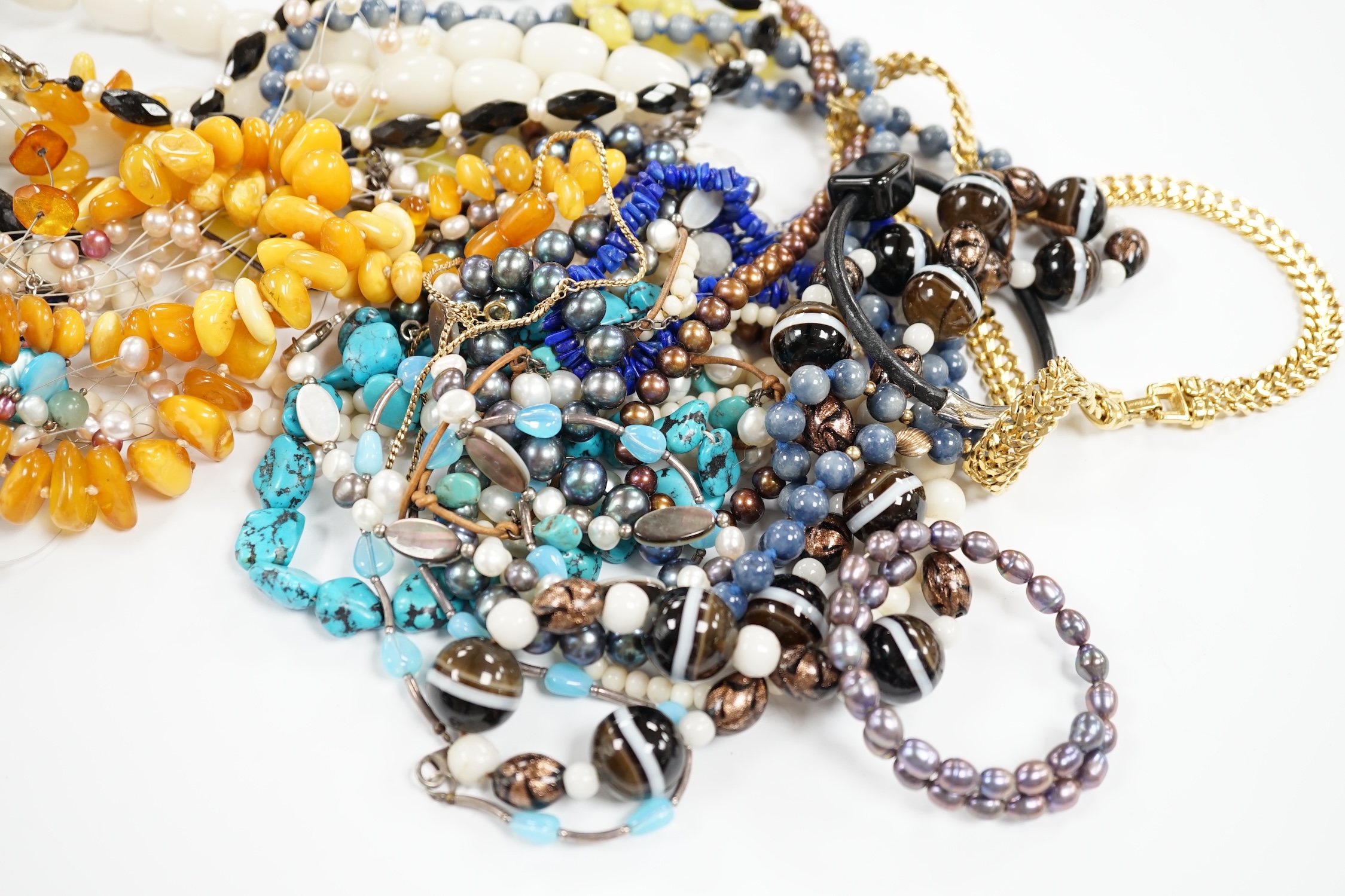 A collection of mixed beaded necklaces including agate, amber, lapis etc.